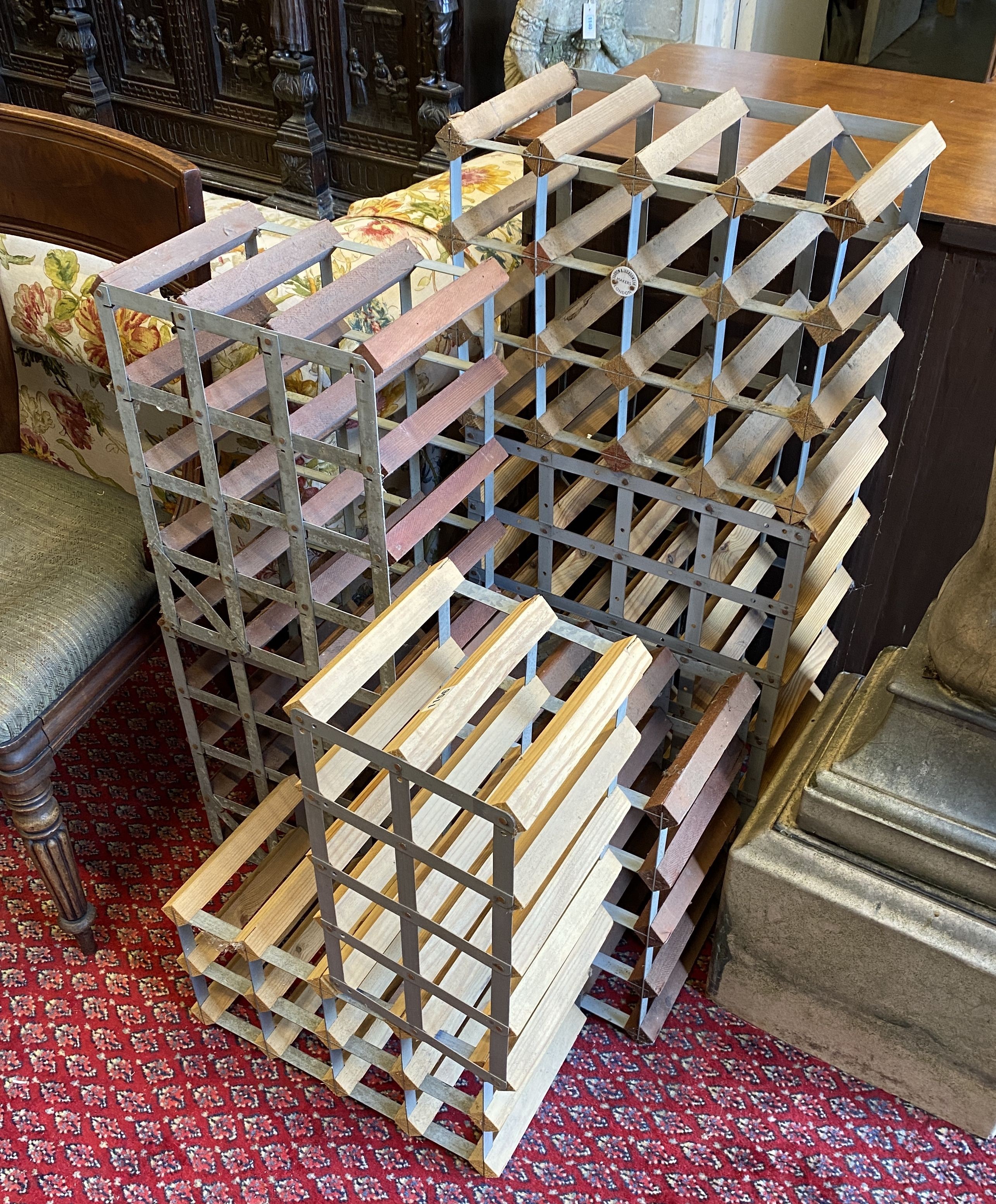 A collection of seven modern modular wine racks, largest 24 bottle capacity
